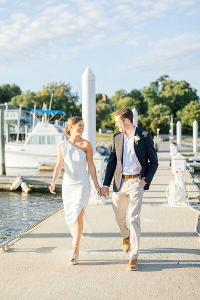bride and groom walking on dock