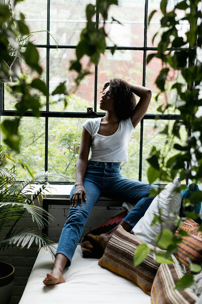 black woman with plants and window