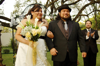 San Antonio Photographers David Castillo and Irene Castillo walking down the isle after they were married