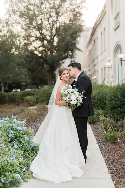 Bride and Groom Portraits with Greenery and White Floral Bouquet