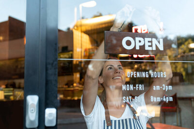 business owner hanging open sign LOYEL