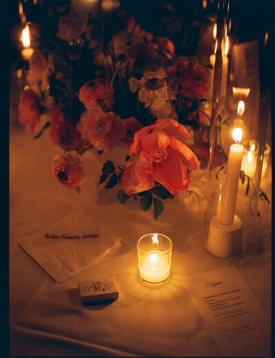 film photo of pink organic florals, candles and a matchbox taken by film wedding photographer 