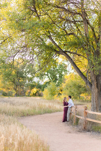 A couple shares an intimate moment while enjoying a nature walk through Fountain Creek Nature Preserve in Colorado Springs by Laramee Love Photography
