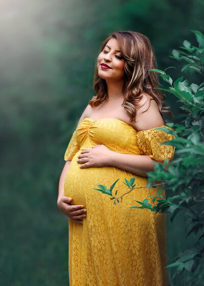 Woman posing in beautiful yellow maternity dress