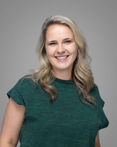 Modern professional headshot of Katya featuring clean, flattering light on a smooth gray backdrop, captured by Liza Hondros Photography in the Sandhills region of North Carolina.
