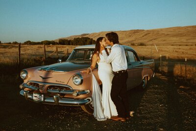 Couple Kissing Next to a Vintage Car - Jillian & Cody | Shadow Lake Ranch Vintage Inspired Wedding Prosser Washington