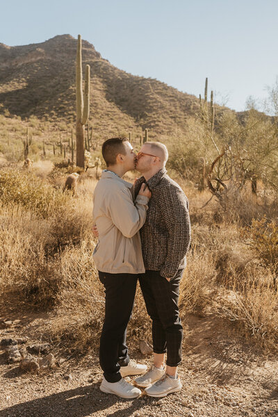 A couple kissing while standing in the desert 