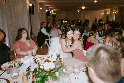 Guests smiling with bride at wedding reception