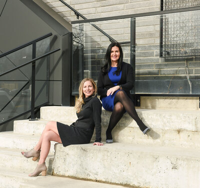 Business women sitting on stairs outside