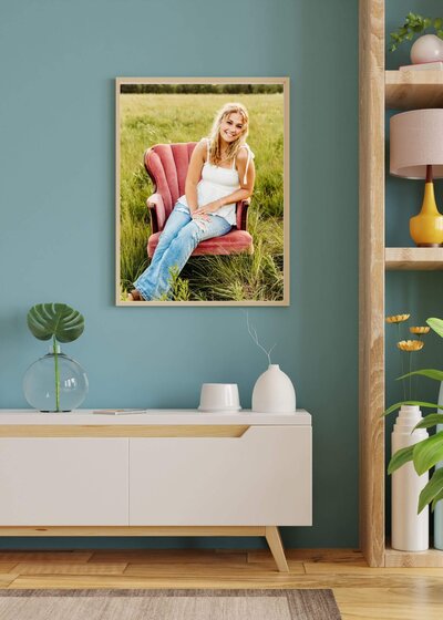 framed senior portrait hanging above a buffet in an entry way