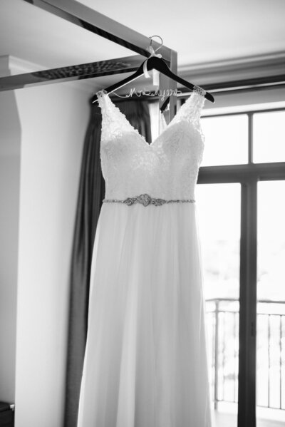 Wedding dress hanging in front of window