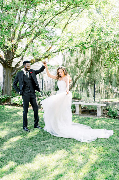 bride and groom dance underneath a willow tree