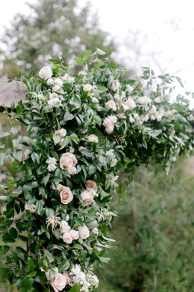 Lush and full rose and greenery arbor