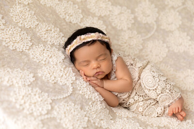 newborn photoshoot with baby in lace outfit