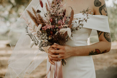 bride holding dried flower bouquest