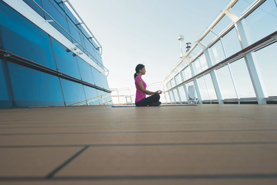 Woman does yoga on cruise ship deck