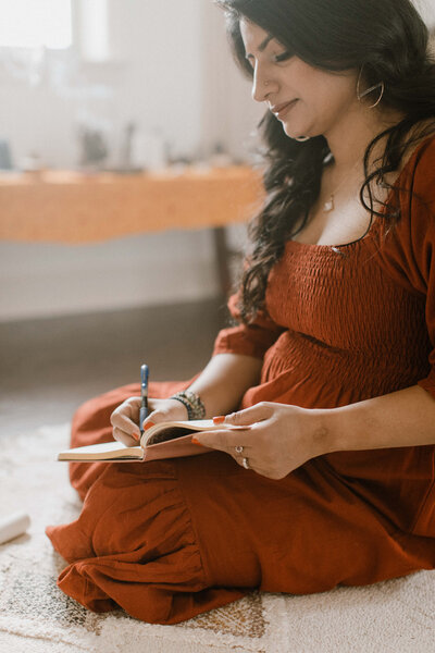 Mindfulness mentor Radhika writing in a notebook