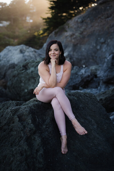 Erika Belanger sitting on a rock at Muir Beach