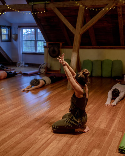 yoga instructor guiding class through a vinyasa flow