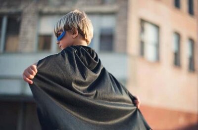 A strong-willed kid in a cape, representing the empowerment and confidence of children who feel understood and valued.