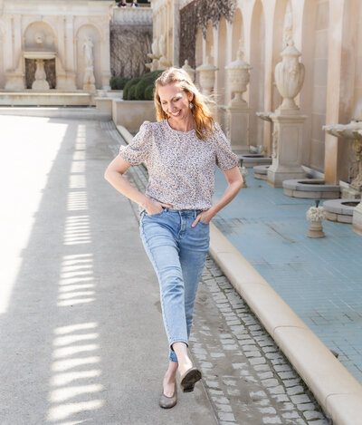 Ingrid Berrios, a Baltimore Branding Photographer, poses in front of a fountain for her personal branding session.