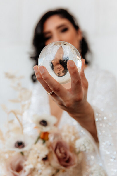 bride holding glass ball