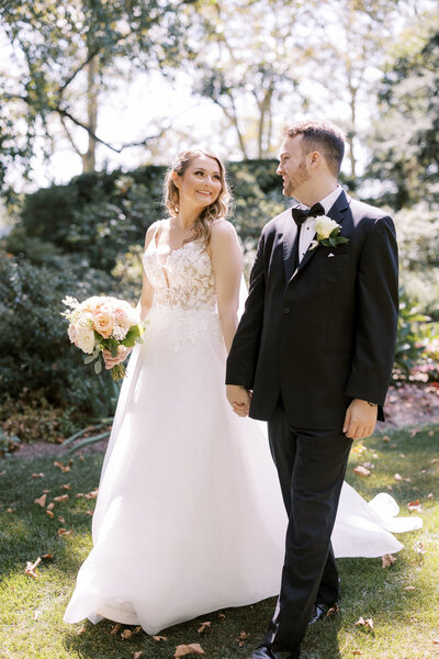Couple walks together in outdoor garden ceremony at the Drumore Estate