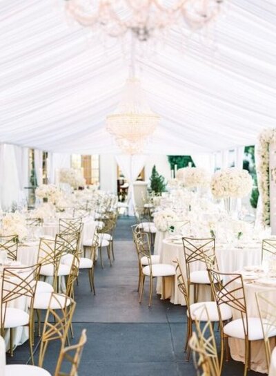 all white tented modern glam wedding with gold chairs