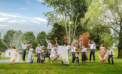 Exuberant Wedding party having fun outside of the Christian Royer House, by Baltimore Wedding Photographer Kimberly Dean