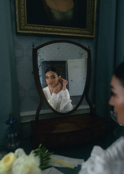 Chic and contemporary bride posing in a luxurious setting, her dress flowing and her smile lighting up the room