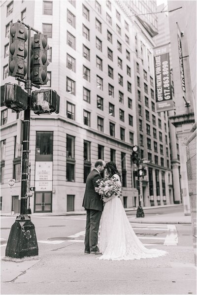Sacramento Wedding Photographers capture bride and groom kissing in street during city bridals