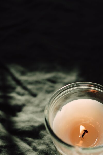 Lit candle in the dark