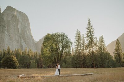 couple standing in front of mountainscape