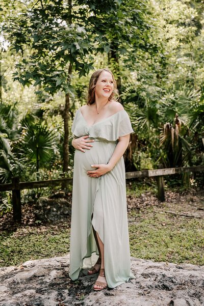 Mom to be in a white gown in Springs near Orlando