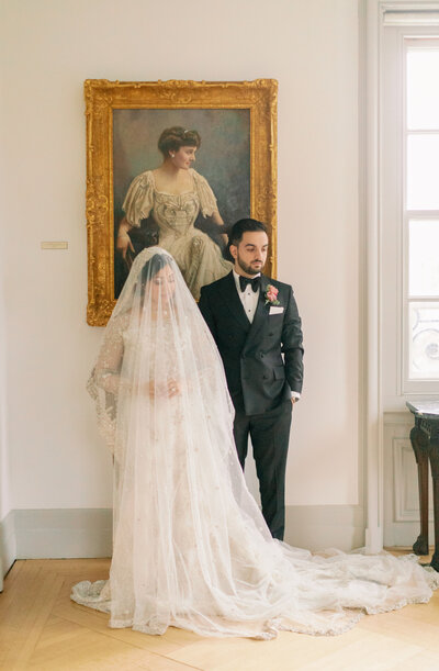 Couple standing together in front of painting, Unique Melody Events & Design (New England Wedding Planners)