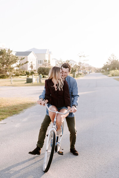 man and woman riding on bicycle together