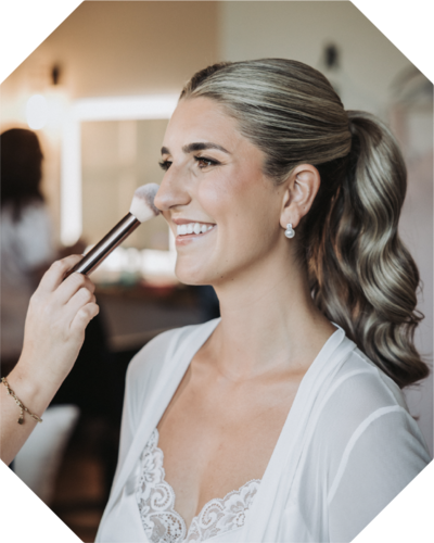 Smiling bride getting wedding makeup - professional photo edit