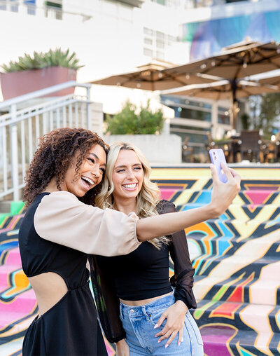 Two women smiling while taking a picture