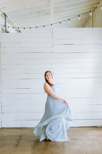 luxury photographer swishing her blue dress