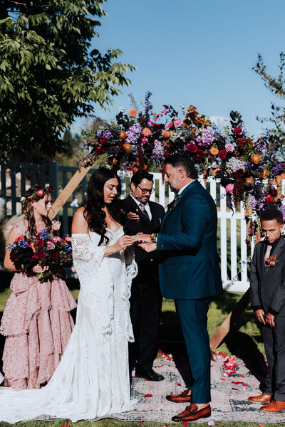 Utah couple taking outdoor wedding photos with white bridal bouquet.