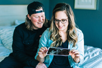 photo of couple looking at baby sonogram