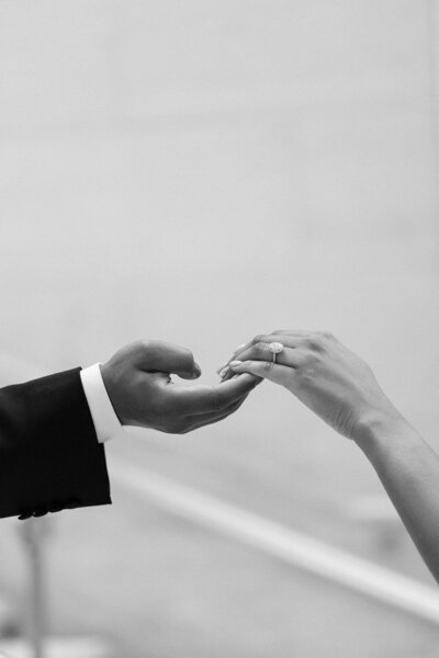 hands holding lightly with engagement ring