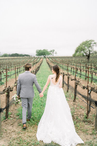 Bride and groom in vineyard at Sunstone Winery in Santa Ynez, CA