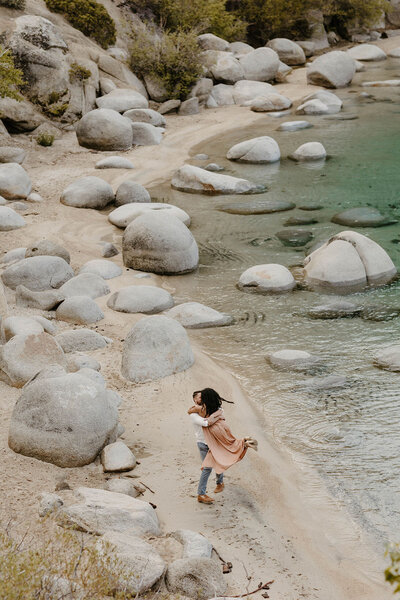 couple dancing on the sand at secret cove in lake tahoe