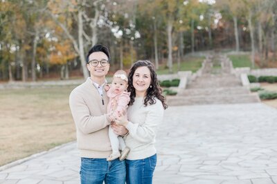 cute family of three at the Steps of Percy Warner Park posing for a photograph