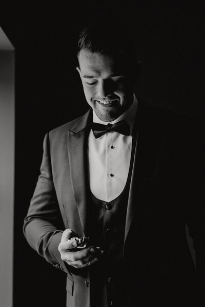 Black and white photo of groom in suit
