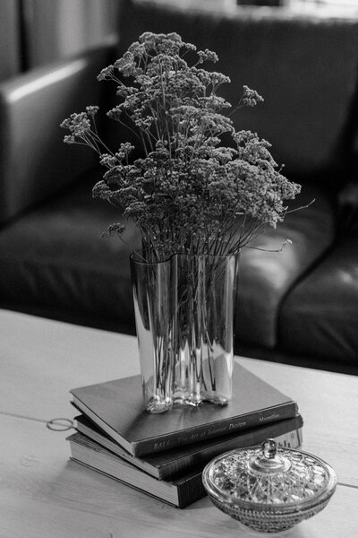 A black and white image of flowers on top of website copywriting books
