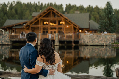 Couple standing in front of their wedding venue in Colorado.