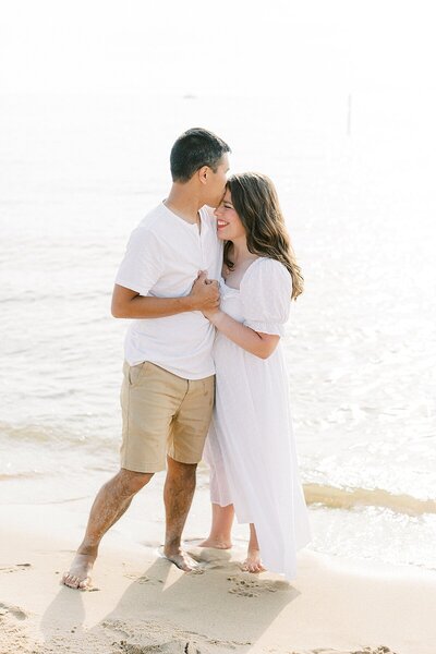 Katelyn stands with her husband, Daniel on a beach.