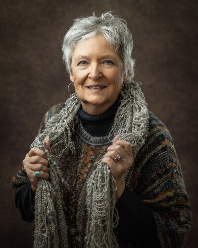 Emotional moment captured during a breast cancer survivor's photography session in Galena.